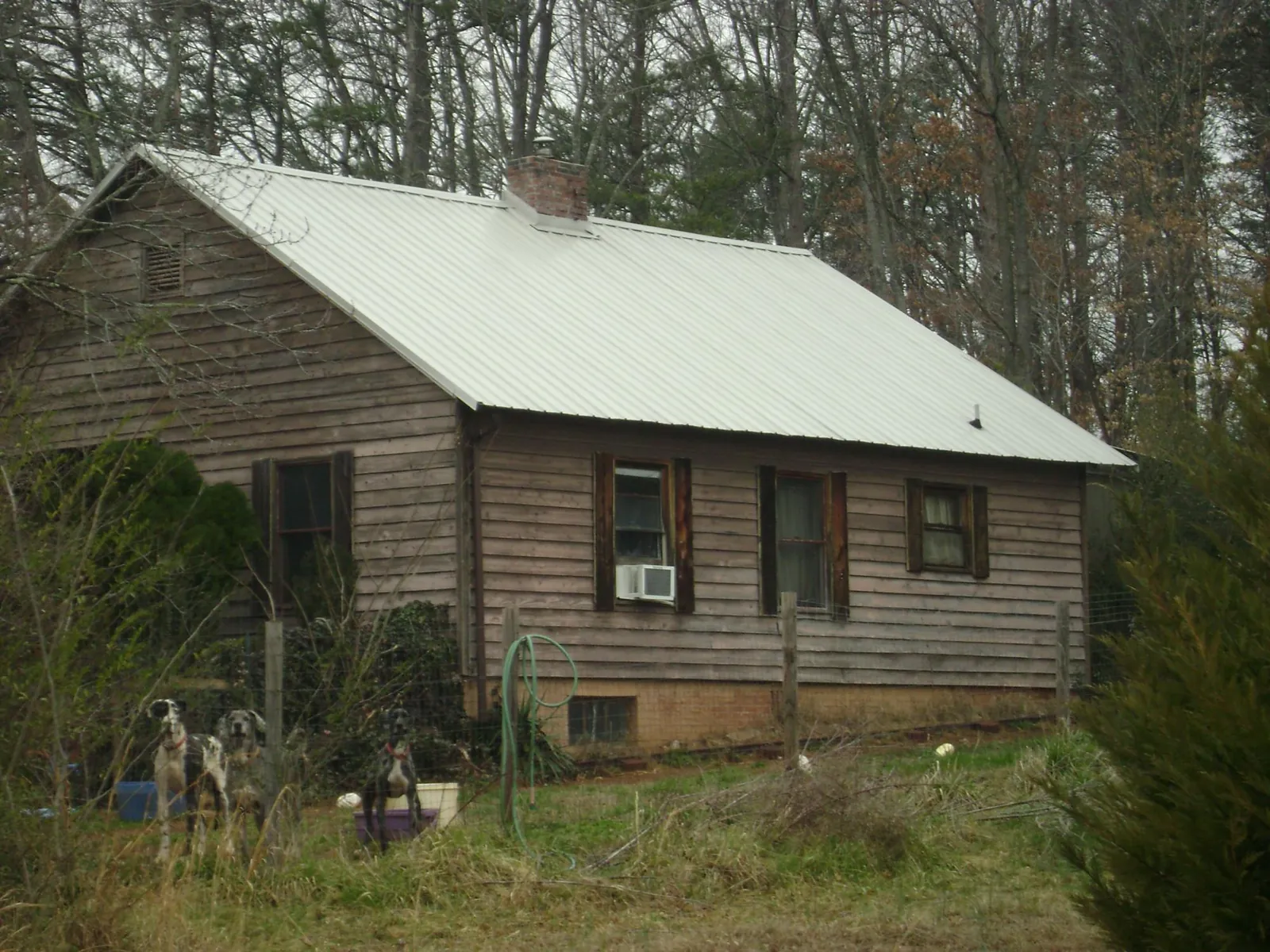 White metal roof on an old wood sided farmhouse, from a Metal Roof Installation job in Peabody